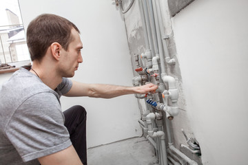 Installation and setting the new gas boiler for hot water and heating. Technician servicing the house heating system.