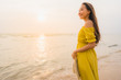 © siraphol - Portrait beautiful young asian woman walk on the beach and sea ocean with smile happy relax
