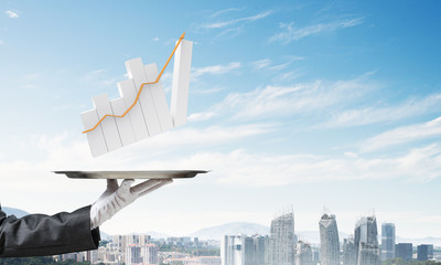 Wall Mural - Hand of waitress presenting growing graph on tray.