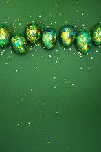 Easter Eggs, Dark Green With Gold On A Green Background. View From Above. Flat Lay.