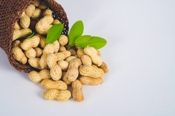 Wall Mural - Peanut spill out of basket on background.