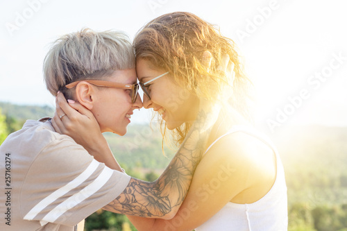 Fényképezés  Beautiful lesbian young couple gently lovingly hugging, equal rights for the lgb