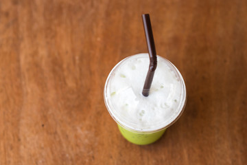 iced green macha tea wooden table