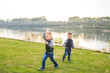 © satura_ - Children and nature concept - Little Brothers trying to catch soap bubbles