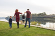 © satura_ - Childhood and nature concept - Family walking by the water