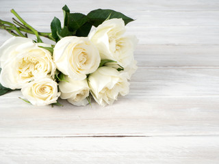 Canvas Print - White roses on a white wooden table