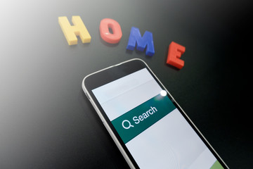 Search for a new home on a mobile device, conceptual photo