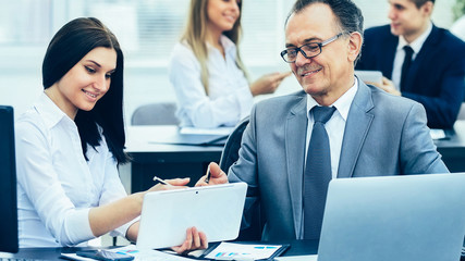 successful businessman and his assistant discuss the work plan