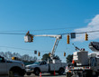 Power company worker repairing traffic light