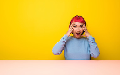 Young woman with pink hair with surprise expression