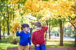 © pahis - happy friends, schoolchildren having fun in autumn park among fallen leaves