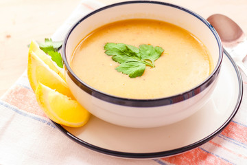 Wall Mural - Traditional lentil soup in a white plate on a wooden table