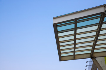 Canvas Print - transparent roof and steel structure with clear blue sky background.  shading for building, exterior decoration, car park lot or out door walk way path