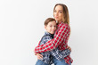 © satura_ - Family, fashion and mother day concept - teen boy hugging his mom on white background