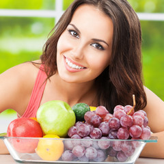 Woman with plate of fruits