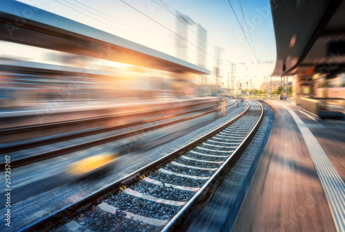 Fotomural Railway station with motion blur effect at sunset
