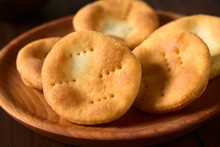 Traditional Chilean Sopaipilla Fried Pastries Made Of A Bread-like Leavened Dough Served On Wooden Plate, Photographed With Natural Light (Selective Focus, Focus In The Middle Of The First Sopaipilla)