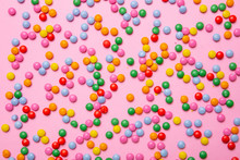 Birthday Concept. Colorful Round Candies On Pink Background