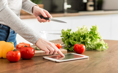 Young trendy woman cooking healthy food in the morning