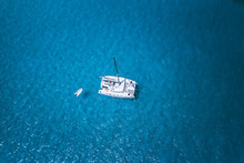 Aerial Drone Photo Of Catamaran Boat At Blue Clear Ocean Water