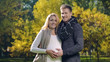 © motortion - Happy pregnant lady and husband stroking belly and looking at camera, parents