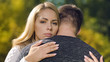 © motortion - Upset couple hugging, looking wistful, fatal disease diagnosis, support and care
