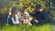 © motortion - Happy family playing with yellow leaves in autumn park, having fun, parenthood