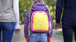 © motortion - Parents and daughter going to school, conscious parenthood, care, back view