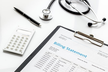 medical treatment bill, calculator and phonendoscope on white background