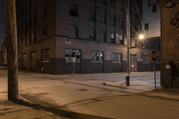 Beautiful street scene with vintage red brick factory buildings at night