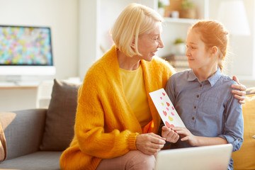 Wall Mural - Portrait of mature woman hugging teenage daughter and smiling happily on Mothers day, copy space