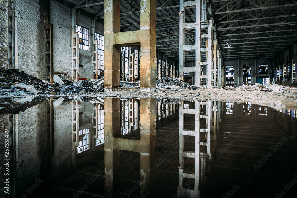 Inside of flooded dirty abandoned ruined industrial building with water ...