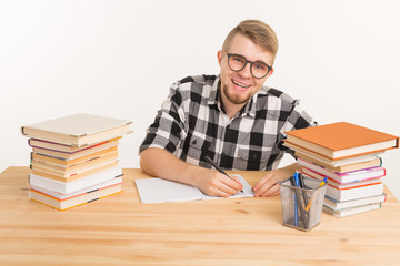 Education, study, knowledge concept - Smiling young student preparing for exam