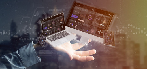 Wall Mural - businessman holding devices connected to a cloud multimedia network 3d rendering