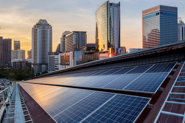 Solar Panel Photovoltaic installation on a Roof of factory, sunny blue sky background, alternative electricity source - Sustainable Resources Concept.