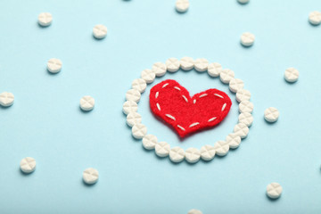 Wall Mural - Aspirin tablets and red heart. Cardiology and medicine, healthcare and pharmacy concept.