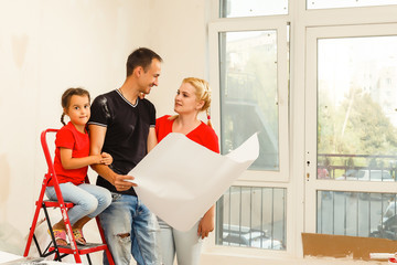 Happy family paint wall at home.