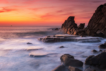 amazing sunset landscape at rocky beach	