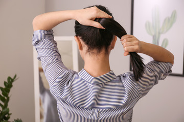 Woman doing hair at home