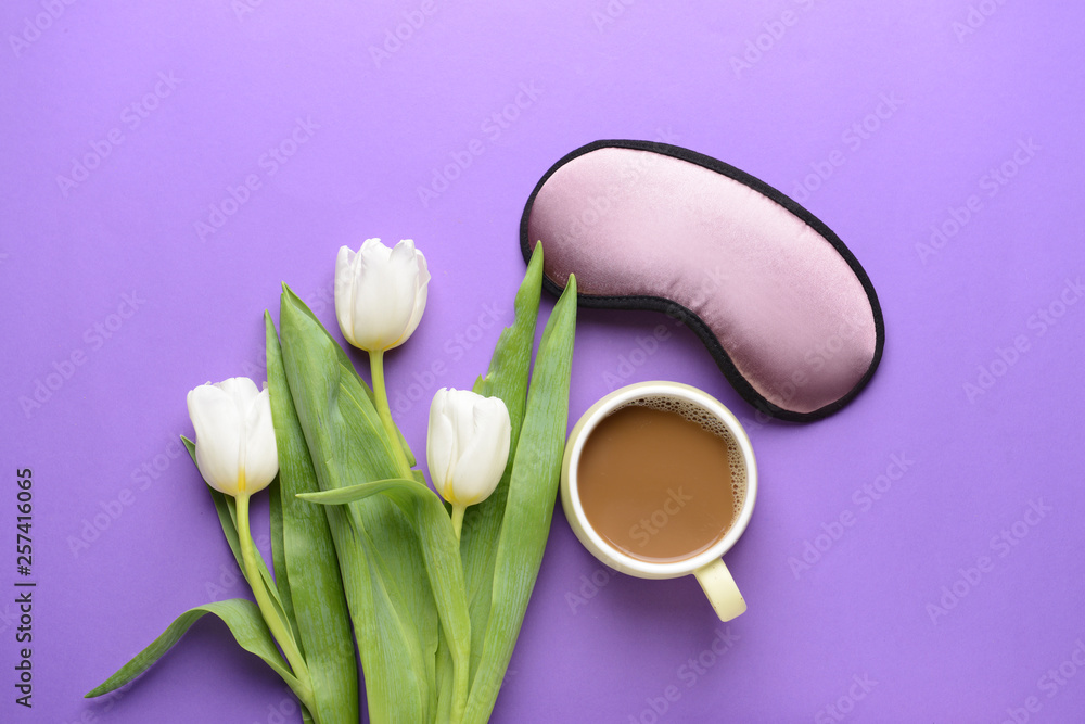 Composition with sleep mask, flowers and coffee on color background