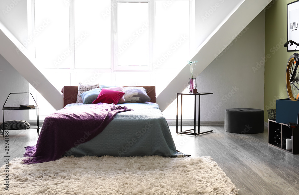 Big soft bed in interior of room