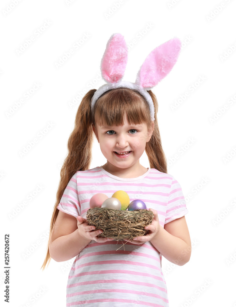 Cute little girl with Easter eggs and bunny ears on white background