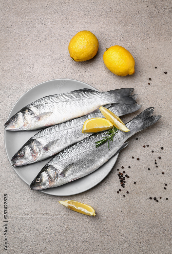 Plate with fresh fish on table