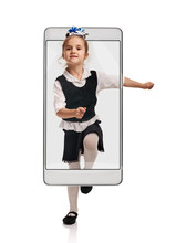 Cute Happy Small Girl In Uniform Going To School, Concept Virtual Reality Of The Smartphone. Going Out Of The Device