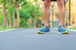 © Jo Panuwat D - Young athlete man with running shoes in the park outdoor, male runner ready for jogging on the road outside, asian Fitness walking and exercise on footpath in morning. wellness and sport concepts