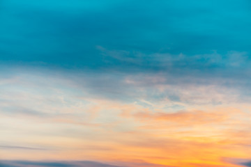 Wall Mural - sunset sky with orange yellow light clouds. colorful smooth blue sky gradient. natural background of