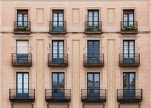 Windows And Balconies In Row On Facade Of Historic Building