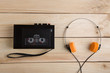 © Sensay - Old portable cassette player on a wooden background