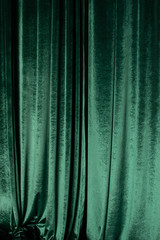 green curtain of luxurious velvet on the theater stage. copy space. the concept of music and theatri