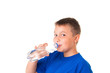 © Yarkovoy - Child drinks clean water from bottle isolated on white background.The boy is wearing a blue T-shirt